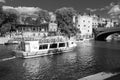 Passenger Cruise Boat Travelling Along an Urban River.