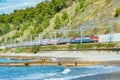 Passenger double deck train moves along Black sea coast