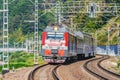 Passenger double deck train moves along the mountains Royalty Free Stock Photo