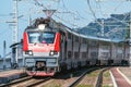 Passenger double deck train moves along the platform by Black Sea