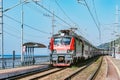 Passenger double deck train moves along the platform and Black sea shore. Sochi