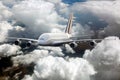 Passenger double decker plane fly high in the cloudy sky. Front view