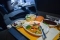 Passenger eats food on Board the plane Royalty Free Stock Photo