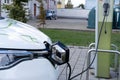 passenger electric reno car replenishes battery at charging station, alternative energy development concept, electric vehicle