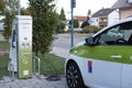 passenger electric reno car replenishes battery at charging station, alternative energy development concept, electric vehicle