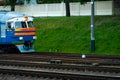 A passenger electric train passes by the railway during sunset. A major railway interchange on the territory of the station. A Royalty Free Stock Photo