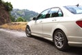 Passenger expensive white car on a dusty country road Royalty Free Stock Photo