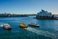 Passenger ferries sail past the Sidney Opera House,