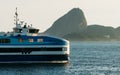 Passenger Ferry boat crossing Guanabara Bay adequately named Pao de Acucar with the actual Pao de Acucar or Sugarloaf Mountain in