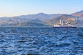 Passenger ferry with mountains and cityscape in the background. August 4, 2025 Izmir Turkey Royalty Free Stock Photo