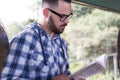 Passenger guy wearing glasses reading a book. Concept of concentration, journey, motivation. Royalty Free Stock Photo