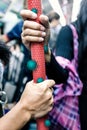 Passenger hands holding handle in public transportation like subway