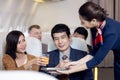 Passenger have orange juice served by an air hostess in airplane, Flight attendants serve on board Royalty Free Stock Photo