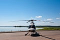 Passenger helicopter against the background of blue sky and lake.