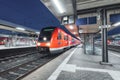 Passenger high speed train on the railway station at night in Europe Royalty Free Stock Photo