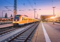 Passenger high speed train on the railway station at sunset Royalty Free Stock Photo