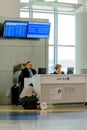 Passenger inquiring from an airline representative at a modern a
