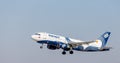 Passenger jet aircraft Airbus A319 of Aurora Airlines in a blue sky. Aviation and transportation