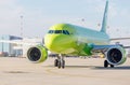 Passenger jet aircraft Airbus A320 of S7 Airlines on runway and ready to take off. Airport terminal on background.