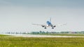 Passenger jet aircraft landing on a runway on a sunny day. Royalty Free Stock Photo