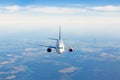 Passenger jet airplane flying in clear sky to destination Royalty Free Stock Photo