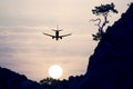 Passenger jet plane flying in the evening sky at sunset Royalty Free Stock Photo