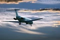 Passenger jet plane flying in the evening sky at sunset Royalty Free Stock Photo