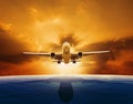 Passenger jet plane flying over beautiful sea level with sun set