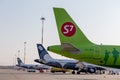 Passenger jets of S7 Airlines and Aurora Airlines on airfield. Airplane fuselages. Aviation and transportation Royalty Free Stock Photo