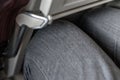 Passenger leg bump into back seat in low-cost commercial airlines. Narrow space for person knee in budget carrier airplane. Cheap