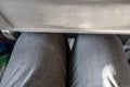 Passenger leg bump into back seat in low-cost commercial airlines. Narrow space for person knee in budget carrier airplane. Cheap