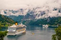 Passenger liner docked in port. Cruise ship in norwegian fjord. Travel destination, tourism. Adventure, discovery Royalty Free Stock Photo