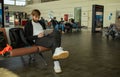 Passenger man sitting at the airport working in his laptop waiting his flight. Royalty Free Stock Photo