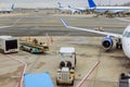 Passenger plane is being serviced by ground services near boarding gate bridge prior to its next departure Royalty Free Stock Photo