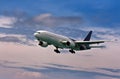 Passenger plane comes in to land on a blue sky