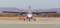 Passenger plane DHC-6-400 of Aurora Airlines on runway, front view. Turboprop engine. Aviation and transportation Royalty Free Stock Photo