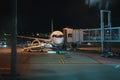 Passenger plane docked to terminal gate Royalty Free Stock Photo