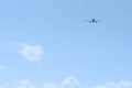 The passenger plane flies away into the blue sky. Back view Royalty Free Stock Photo