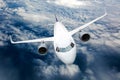 Passenger plane in flight. Aircraft fly above the clouds. Front view. Left heeling