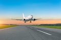 Passenger plane fly up over take off runway from airport at sunset Royalty Free Stock Photo