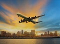 Passenger plane flying above urban scene use for convenience air Royalty Free Stock Photo