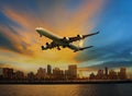 Passenger plane flying above urban scene use for convenience air Royalty Free Stock Photo