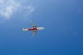 Passenger plane flying in the blue sunny sky, bottom view