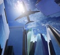 Passenger plane flying ove rmodern office building against blue