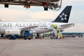 Passenger plane German airline STAR ALLIANCE Airbus A-319 D-AILS. Airport apron workers. Maintenance refueling and