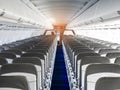 Passenger plane interior. Empty airplane interior with chairs and folding tables in seat back. Cabin of passenger aircraft, Royalty Free Stock Photo