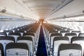 Passenger plane interior. Empty airplane interior with chairs and folding tables in seat back. Cabin of passenger aircraft, Royalty Free Stock Photo