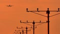 Silhouette of plane landing, runway lights, orange effect Royalty Free Stock Photo