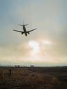 The passenger plane landing at the airport at sunset Royalty Free Stock Photo