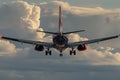 Passenger plane landing with blue sky and white clouds, copy space for text placement